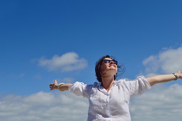 Image showing young woman with spreading arms to sky