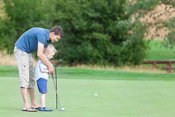 Image showing family of two at the golf course