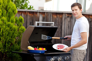 Image showing man grilling food