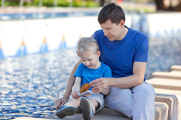 Image showing family of two by the city fountain