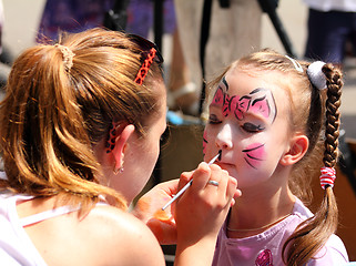 Image showing artist paints on face of little girl