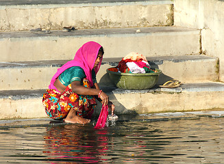 Image showing Indian woman washing clothes in the lake