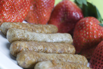 Image showing pork sausage links with strawberries