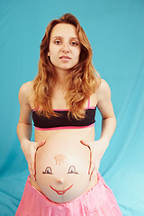 Image showing Pregnant girl with a picture