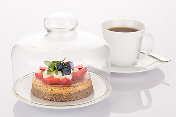 Image showing Cheesecake, glass bell and cup of coffee