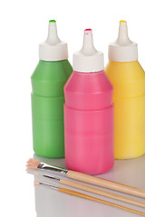 Image showing Bottles of paint and pencils