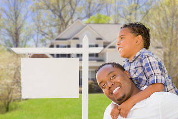 Image showing Father and Son In Front of Blank Real Estate Sign and House