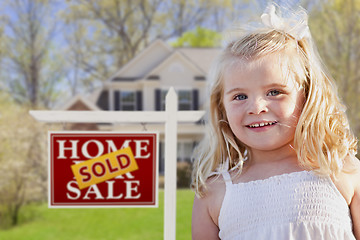 Image showing Cute Girl in Yard with Sold For Sale Real Estate Sign and House