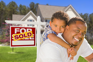 Image showing Mixed Race Father and Son In Front of Real Estate Sign and House