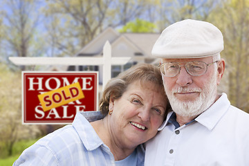 Image showing Senior Couple in Front of Sold Real Estate Sign and House