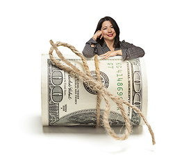 Image showing Hispanic Woman Leaning on a Roll Of Hundred Dollar Bills