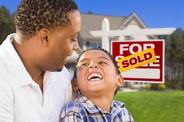 Image showing Mixed Race Father and Son In Front of Real Estate Sign and House