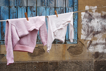 Image showing Sweater and shirt on a clothes line