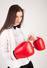 Image showing young businesswoman in boxing gloves