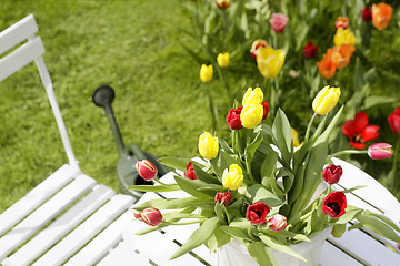 Image showing bouquet of tulips on a garden table