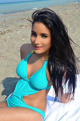 Image showing Girl sitting on beach.