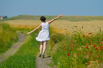 Image showing young woman in wheat field at summer