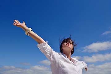 Image showing young woman with spreading arms to sky
