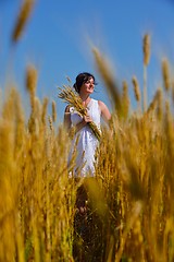 Image showing young woman in wheat field at summer