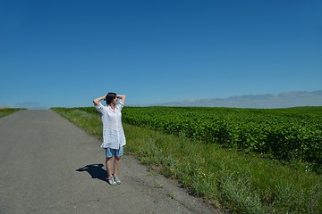 Image showing Young happy woman in green field