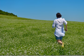 Image showing Young happy woman in green field