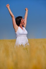 Image showing young woman with spreading arms to sky