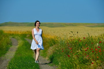 Image showing Young happy woman in green field