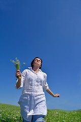 Image showing young woman with spreading arms to sky