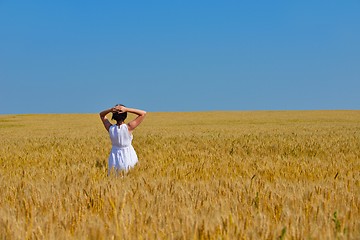 Image showing young woman in wheat field at summer