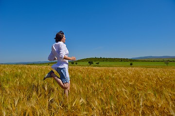 Image showing young woman in wheat field at summer