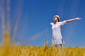 Image showing young woman with spreading arms to sky