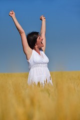 Image showing young woman with spreading arms to sky