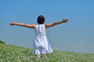 Image showing Young happy woman in green field