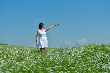 Image showing Young happy woman in green field