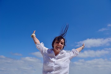 Image showing young woman with spreading arms to sky