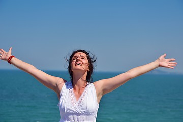 Image showing young woman with spreading arms to sky