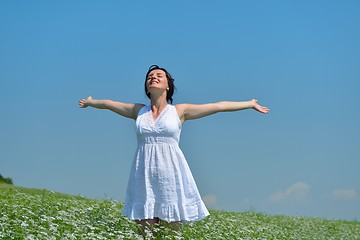 Image showing Young happy woman in green field