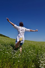 Image showing young woman with spreading arms to sky