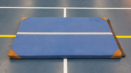 Image showing Very old blue mat on a blue court