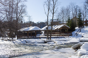 Image showing frozen river bank wooden village houses roof snow 