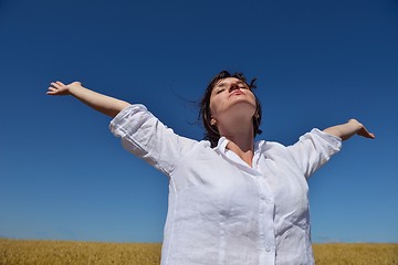 Image showing young woman with spreading arms to sky