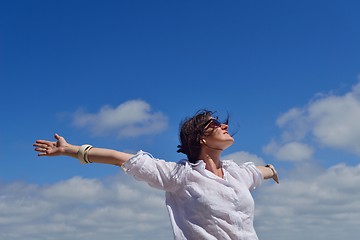 Image showing young woman with spreading arms to sky