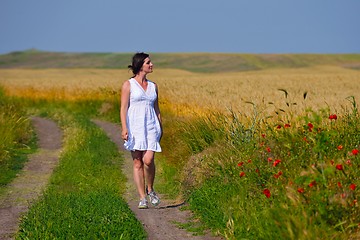 Image showing Young happy woman in green field