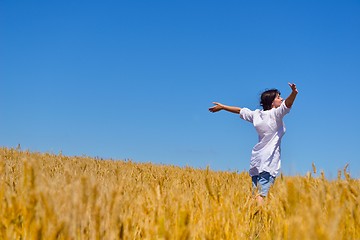 Image showing young woman in wheat field at summer