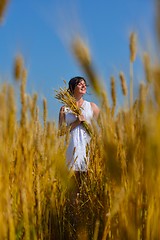 Image showing young woman in wheat field at summer