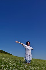 Image showing young woman with spreading arms to sky