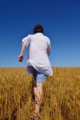 Image showing young woman in wheat field at summer