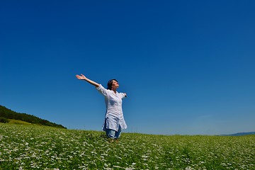 Image showing young woman with spreading arms to sky