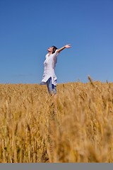 Image showing young woman with spreading arms to sky