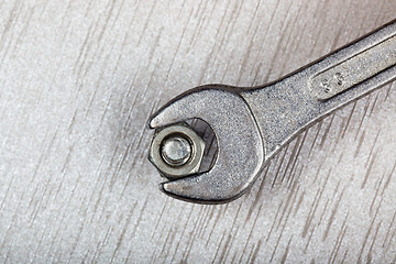 Image showing Wrench, bolt and nut on metal surface